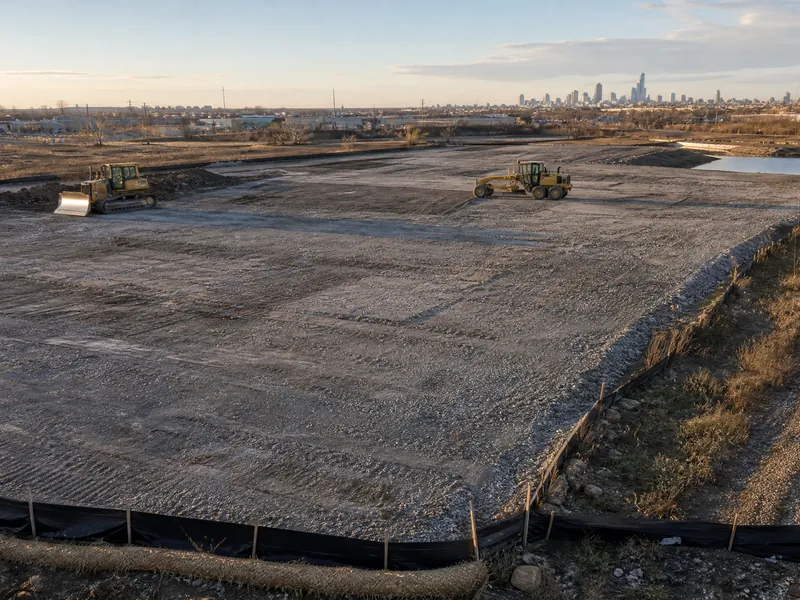 A cleared brownfield site being graded after demolition